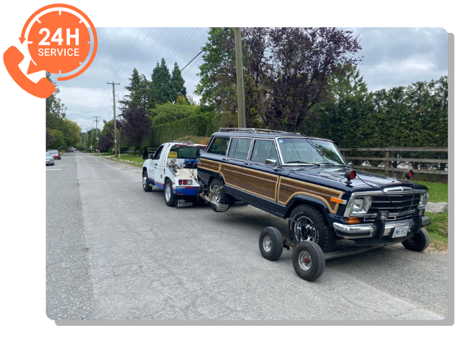 TowMaster Towing truck providing 24-hour roadside assistance towing a vintage SUV